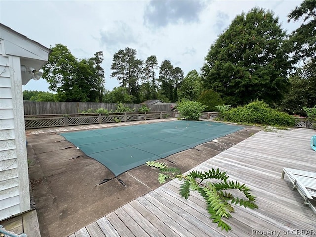 view of swimming pool with a wooden deck