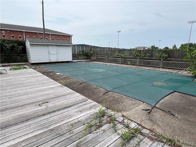 view of pool with a storage shed