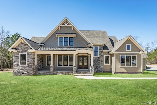 craftsman-style house with a front yard, roof with shingles, a standing seam roof, crawl space, and metal roof