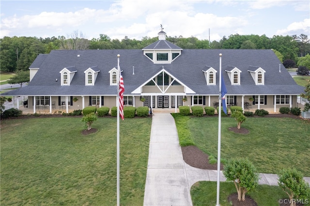 cape cod house featuring a front yard