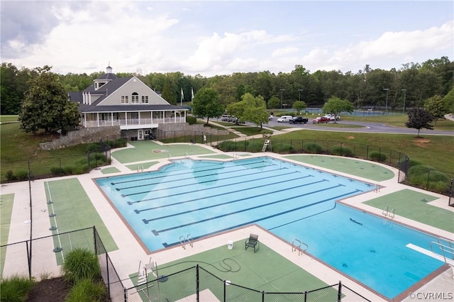 view of pool featuring fence