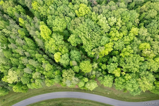 birds eye view of property featuring a view of trees