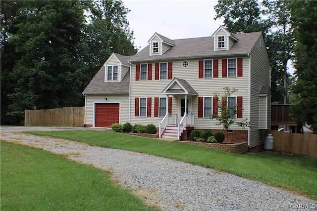 colonial-style house with a garage and a front yard