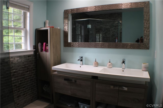 bathroom with a shower with shower door and vanity