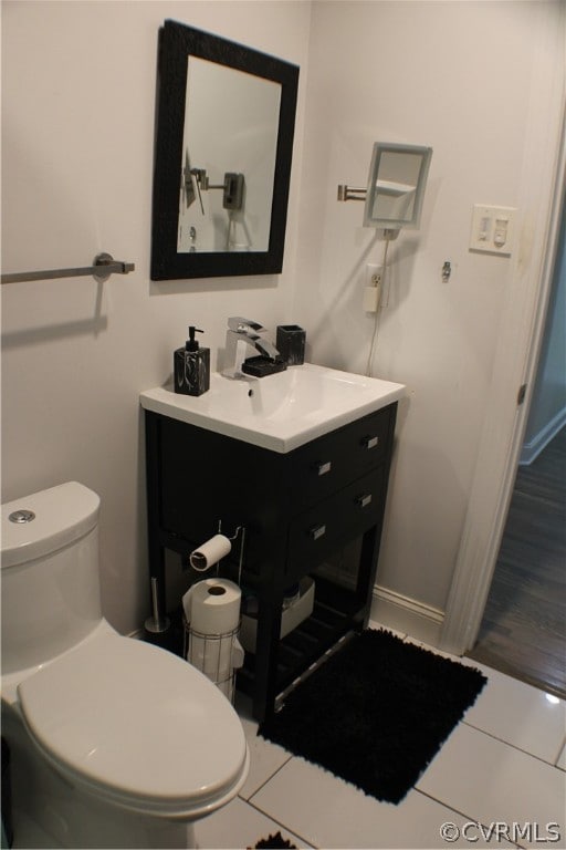 bathroom featuring tile patterned floors, vanity, and toilet