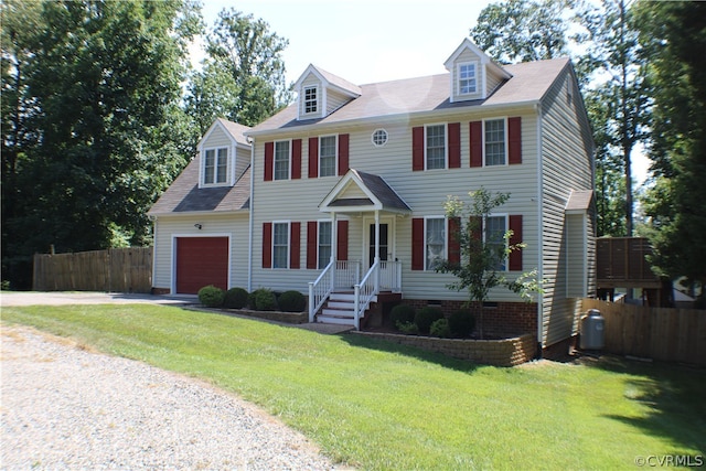 colonial-style house featuring a garage and a front yard