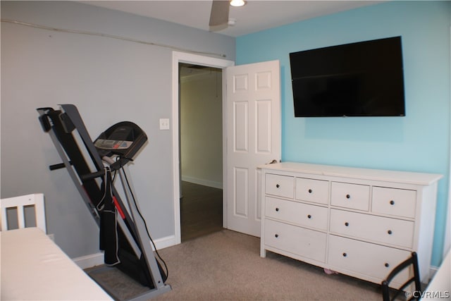 workout room with light colored carpet and ceiling fan