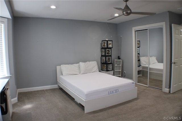 bedroom with a closet, multiple windows, carpet, and ceiling fan