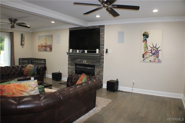 living room featuring ornamental molding, a fireplace, wood-type flooring, and ceiling fan