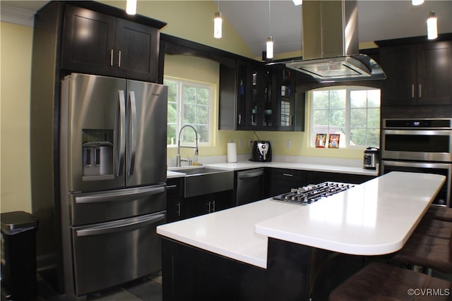 kitchen featuring island range hood, appliances with stainless steel finishes, a kitchen bar, and a center island