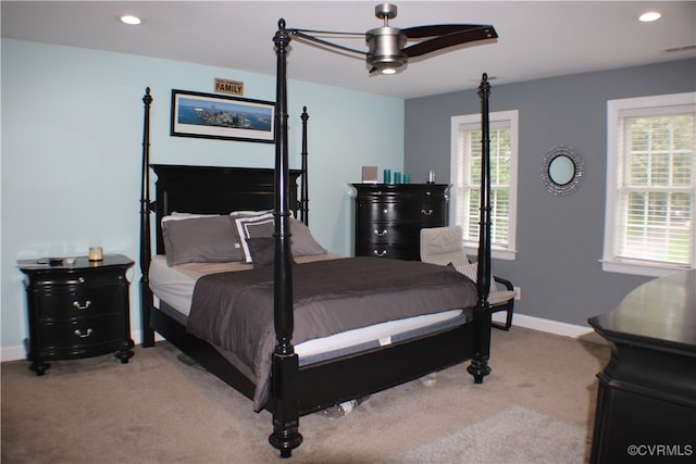 carpeted bedroom with ceiling fan and multiple windows