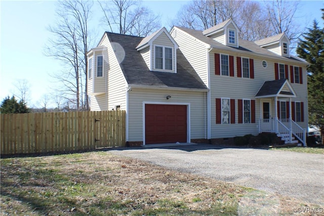 view of front facade with crawl space, gravel driveway, an attached garage, and fence