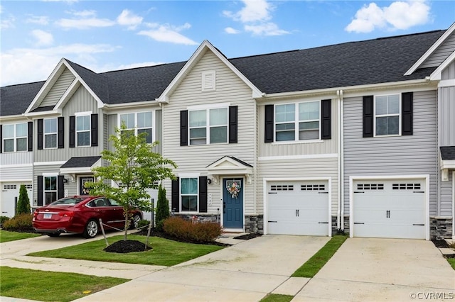 7740 Baron Berkley Ln, New Kent, VA 23124 - townhome / multi-family property featuring driveway, stone siding, board and batten siding, and an attached garage