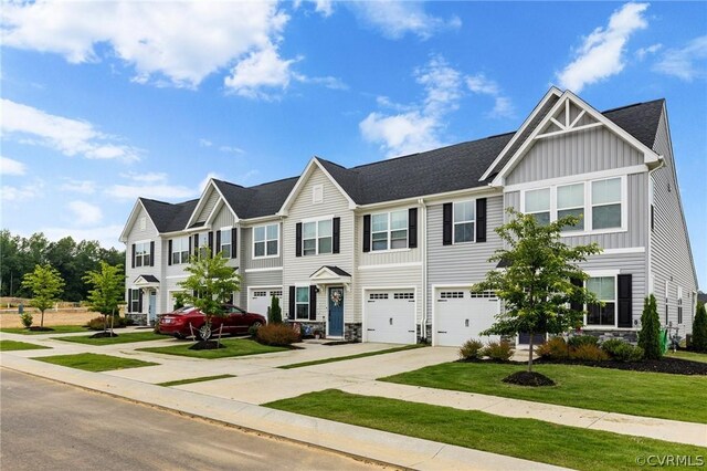 7740 Baron Berkley Ln, New Kent, VA 23124 - townhome / multi-family property with driveway, board and batten siding, stone siding, and a garage