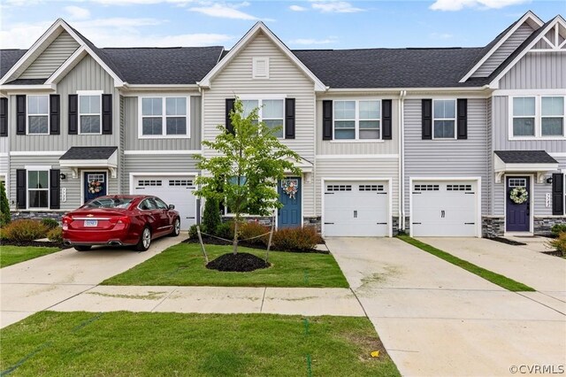 7740 Baron Berkley Ln, New Kent, VA 23124 - townhome / multi-family property with board and batten siding, driveway, a garage, stone siding, and roof with shingles