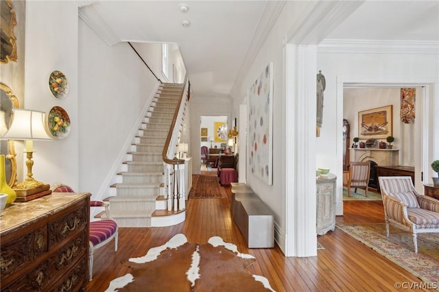 entryway with crown molding and hardwood / wood-style flooring