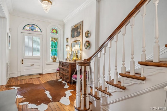 entryway featuring light hardwood / wood-style floors and ornamental molding