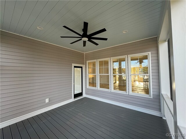 wooden terrace featuring ceiling fan