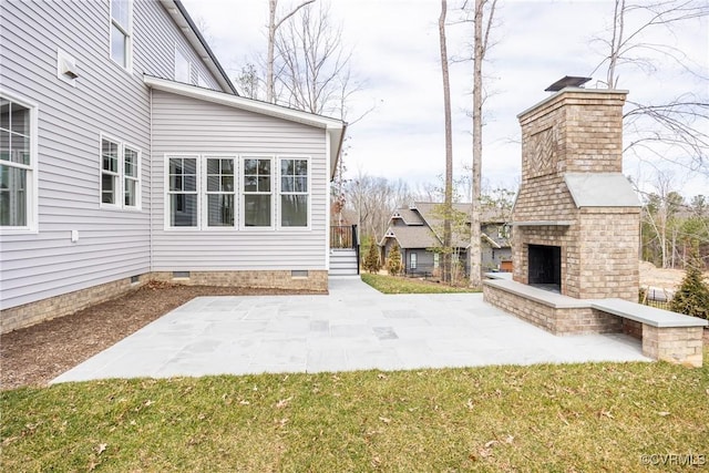 view of patio featuring an outdoor brick fireplace