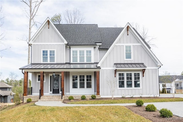 modern farmhouse style home with board and batten siding, a shingled roof, a standing seam roof, and a front yard