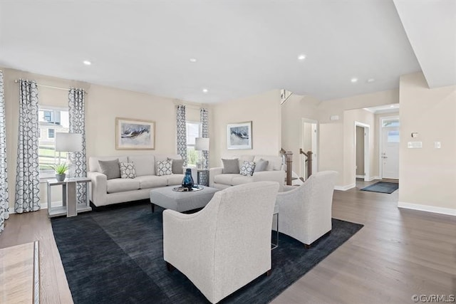 living room featuring plenty of natural light and dark hardwood / wood-style floors