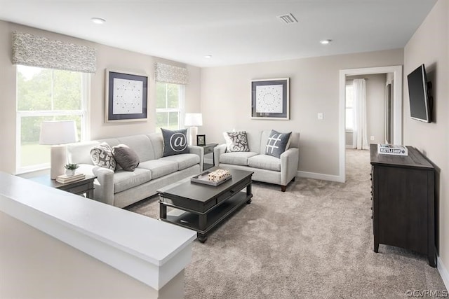 carpeted living room with a healthy amount of sunlight