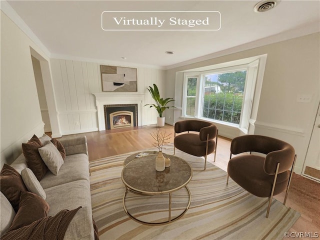 living room featuring hardwood / wood-style floors and ornamental molding