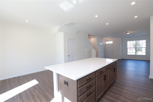 kitchen featuring dark wood-type flooring and a center island