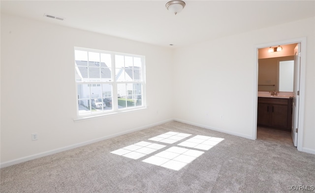 carpeted empty room with sink