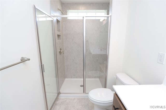 bathroom with tile patterned flooring, an enclosed shower, vanity, and toilet