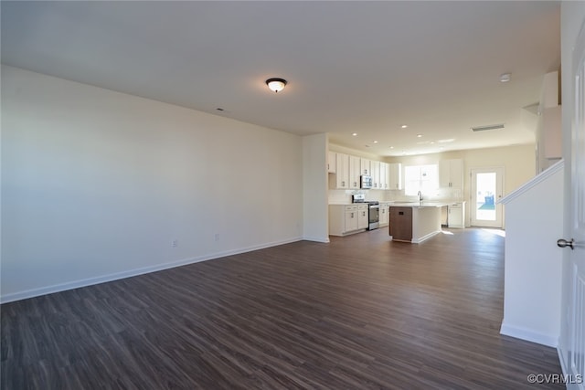 unfurnished living room with dark wood-type flooring and sink