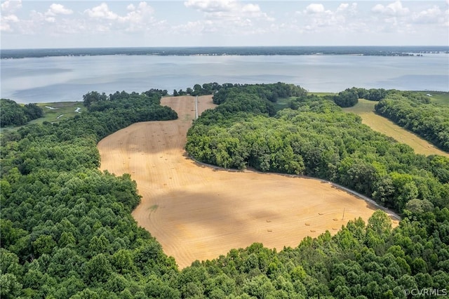 aerial view with a forest view and a water view