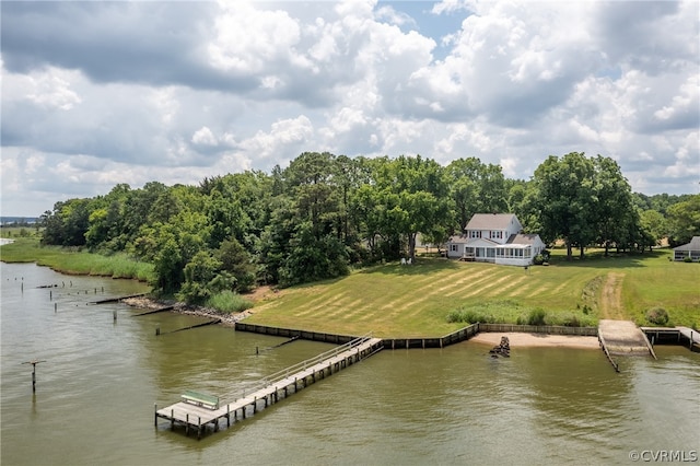 dock area with a lawn and a water view