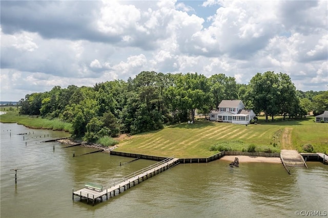 view of dock featuring a lawn and a water view