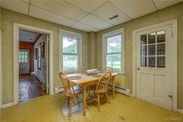 dining room with visible vents, a paneled ceiling, and a baseboard radiator