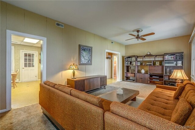 living room featuring carpet flooring and ceiling fan