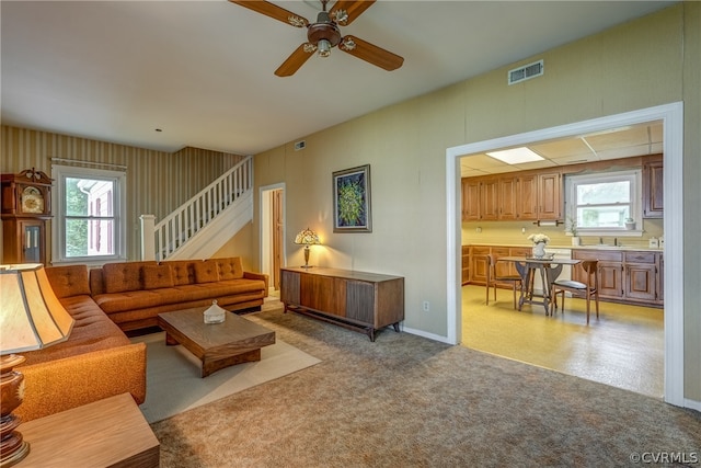 living room featuring ceiling fan and sink