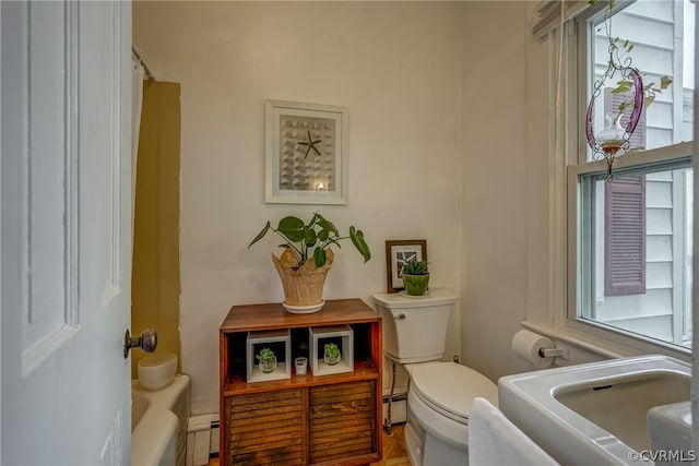 full bathroom featuring sink, a baseboard radiator, toilet, and shower / tub combo with curtain