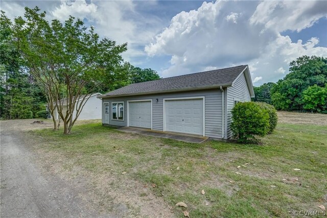 garage featuring a yard