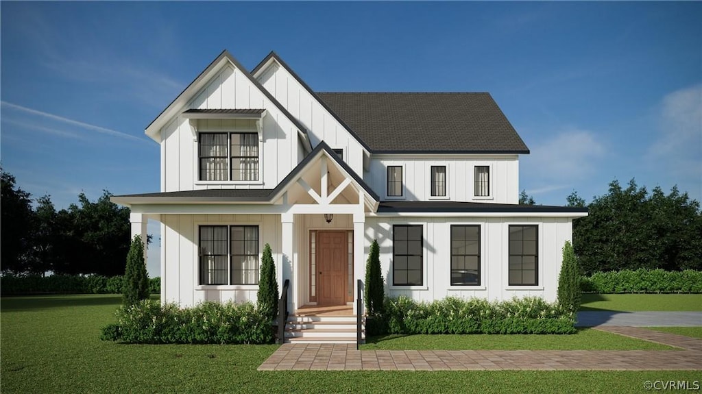 modern inspired farmhouse with board and batten siding, a front yard, and roof with shingles