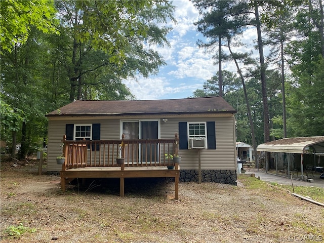 view of front of home featuring a deck and a carport