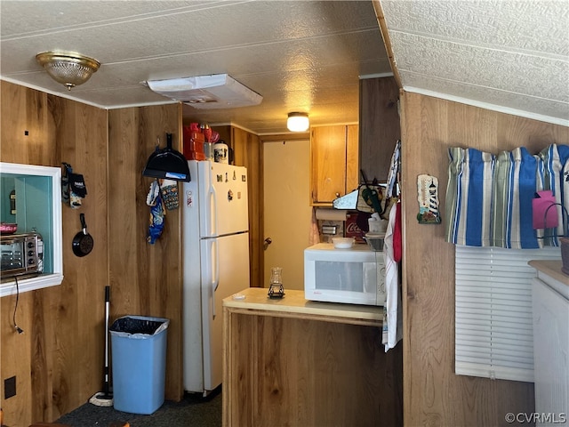 kitchen with white appliances and wooden walls