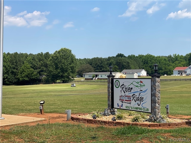 community / neighborhood sign with a lawn