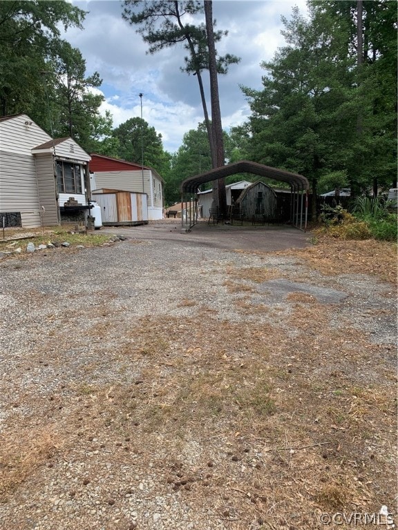 view of yard featuring an outdoor structure and a carport