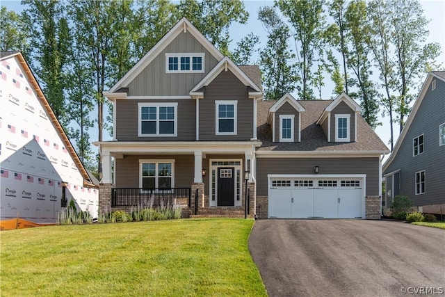 craftsman-style house featuring a porch, a front lawn, and a garage