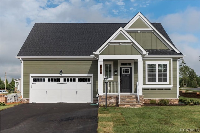 craftsman-style house featuring a front lawn and a garage