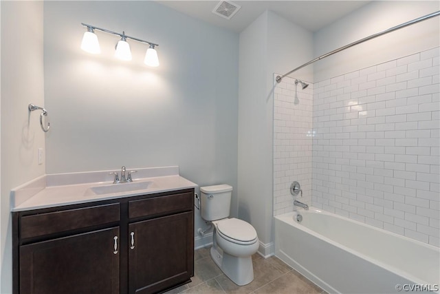 full bathroom with toilet, tile patterned flooring, tiled shower / bath, and vanity