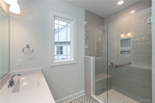 bathroom featuring sink and an enclosed shower