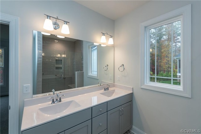 bathroom featuring a shower with door and vanity