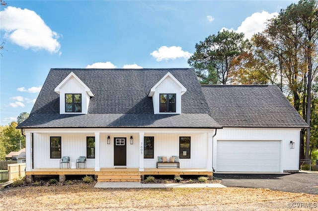 modern farmhouse with a porch and a garage